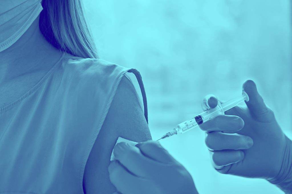Blue washed image of vaccine being injected into arm