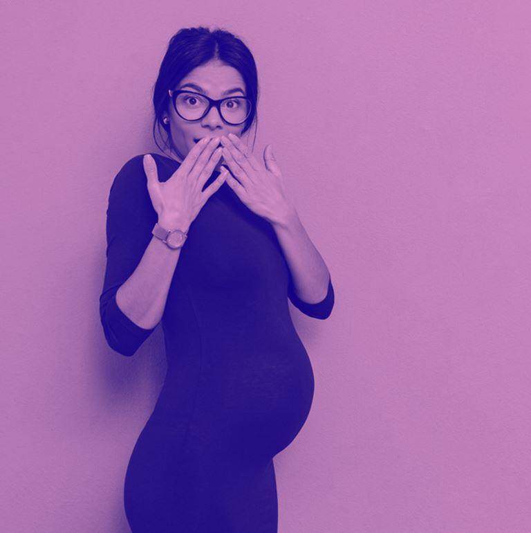 pregnant woman with hands in front of mouth