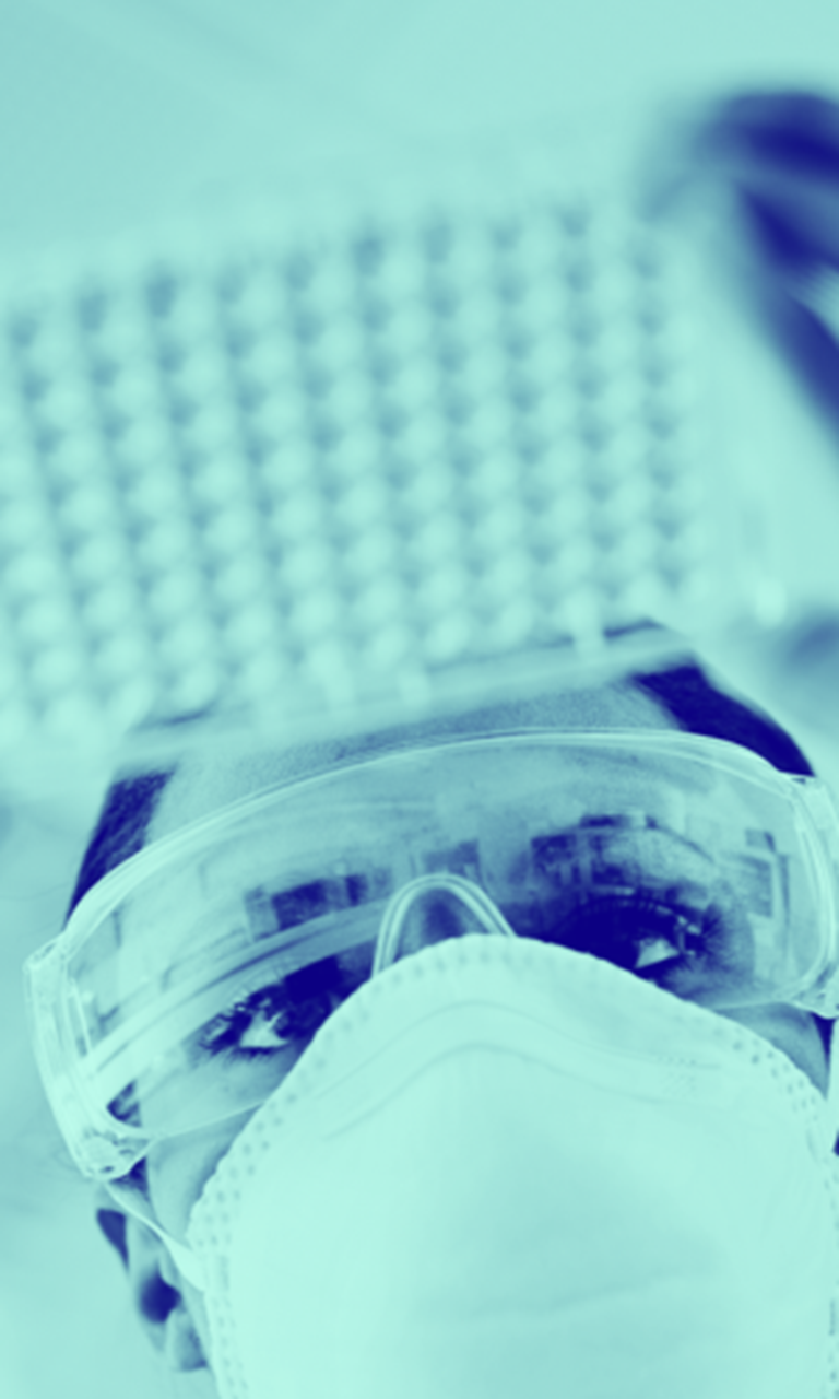 scientist in lab looking at a slide