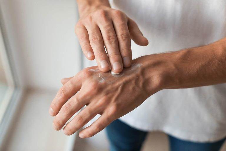 Man applying hand cream