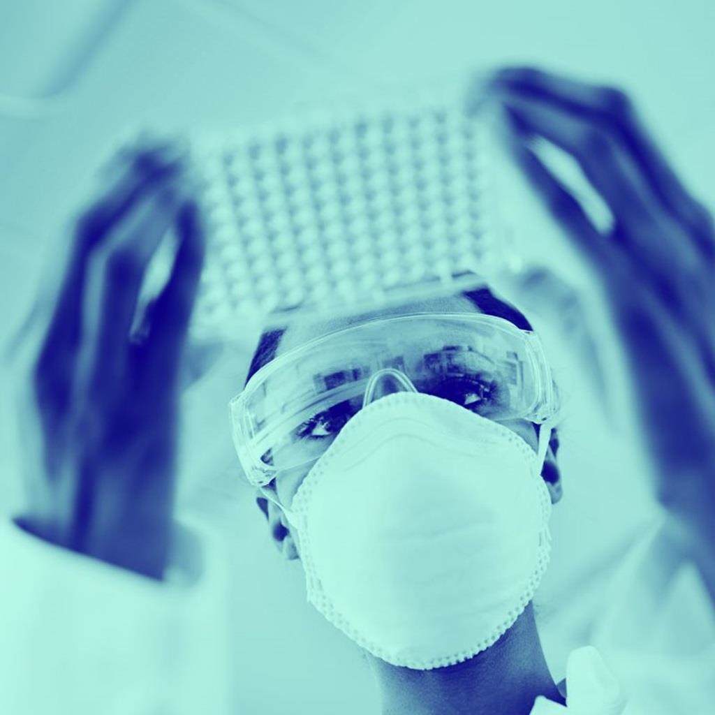 scientist in lab formulating with adjuvants
